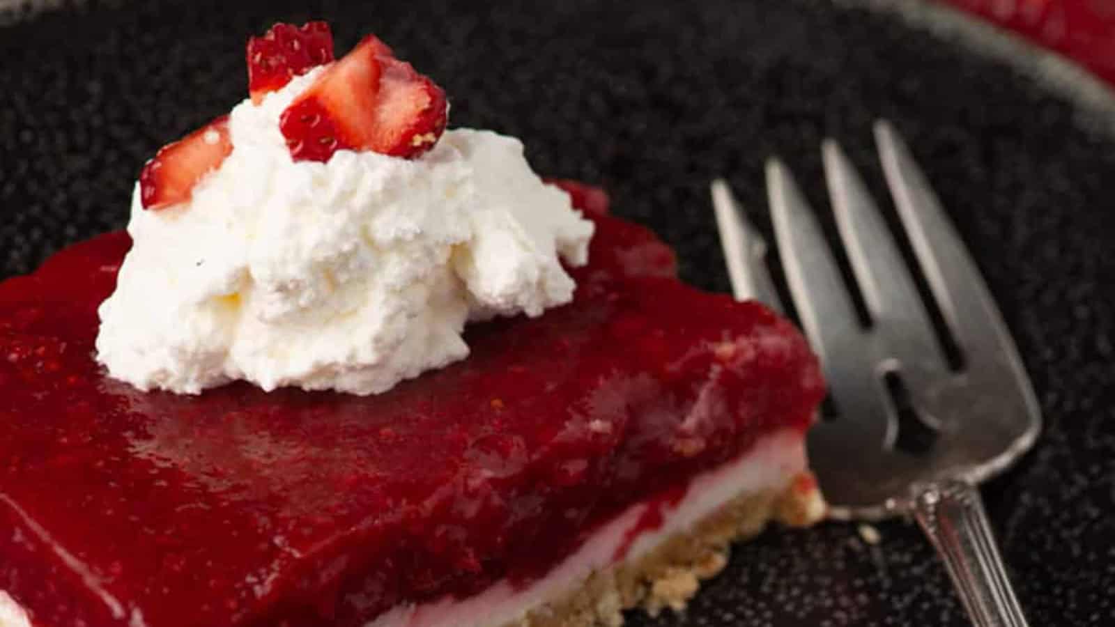 Strawberry pretzel salad layered with creamy filling, fresh strawberries, and gelatin topping.