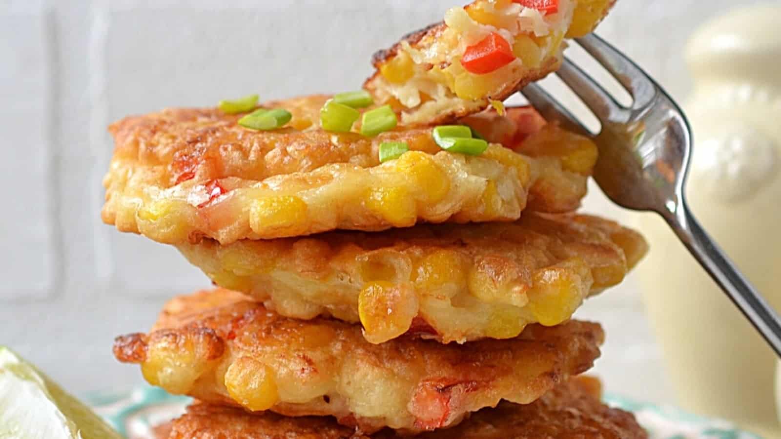 Stack of Mexican corn cakes on a white plate with a fork.