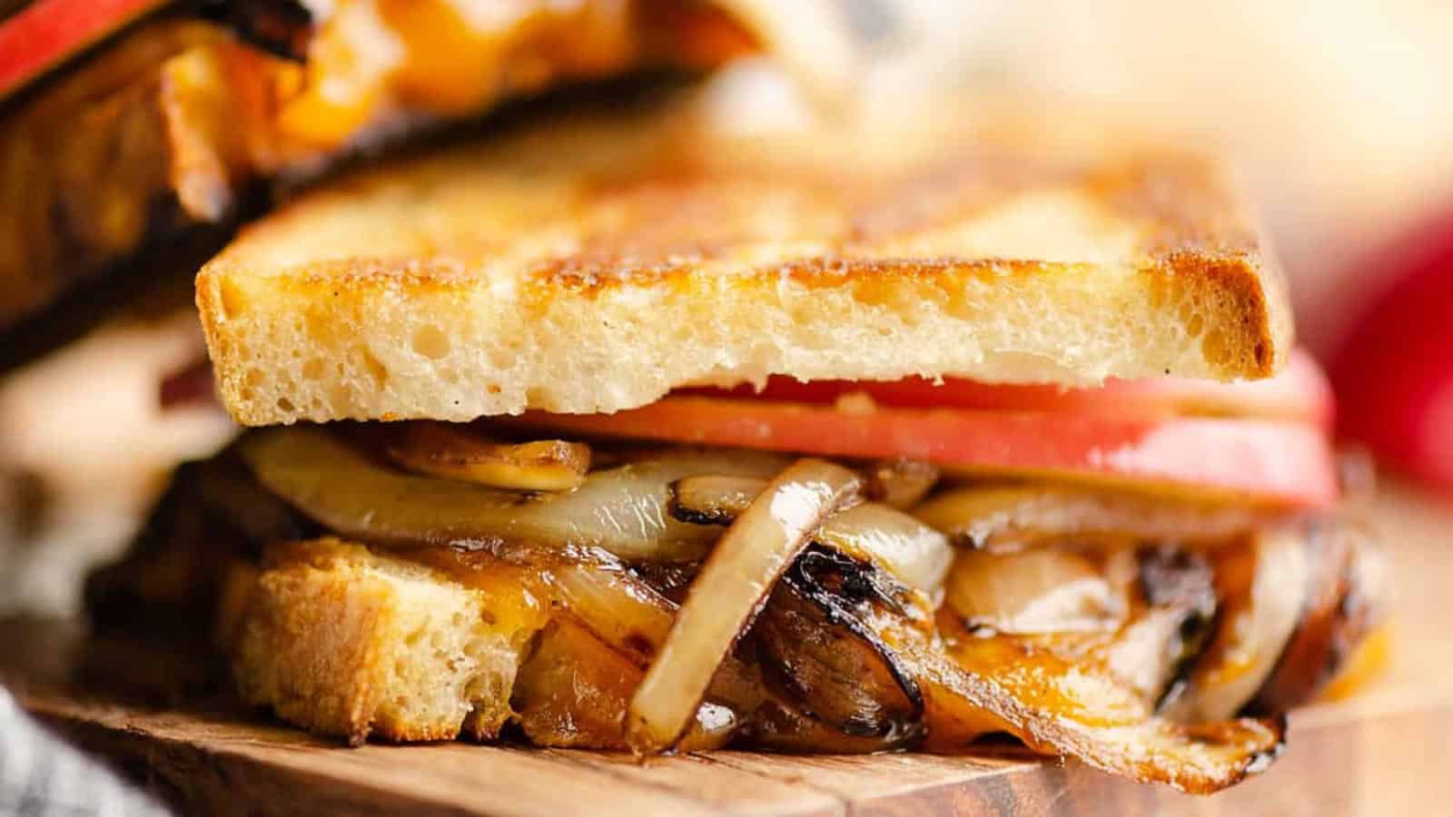 Grilled cheese sandwich filled with apple slices, balsamic onions, and melted cheese.