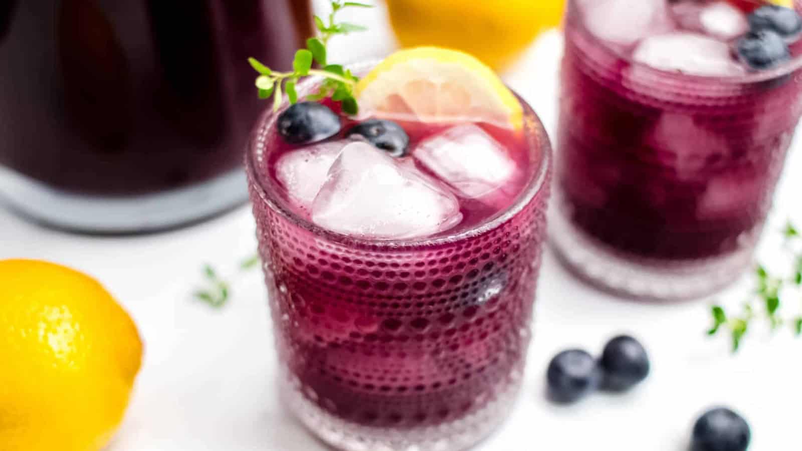 Blueberry lemonade with fresh blueberries and lemon slices served over ice.