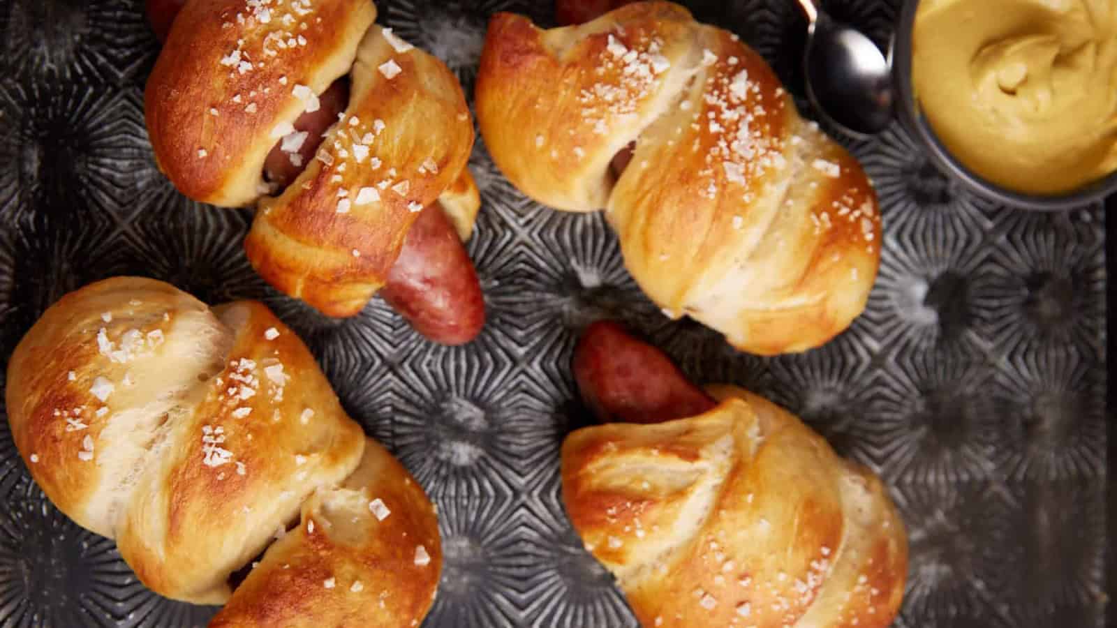 Pretzel brats nestled in soft pretzel buns with classic toppings.