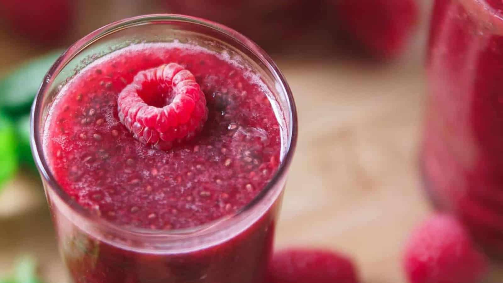 Raspberry chia lemonade with fresh raspberries, lemon slices, and chia seeds.