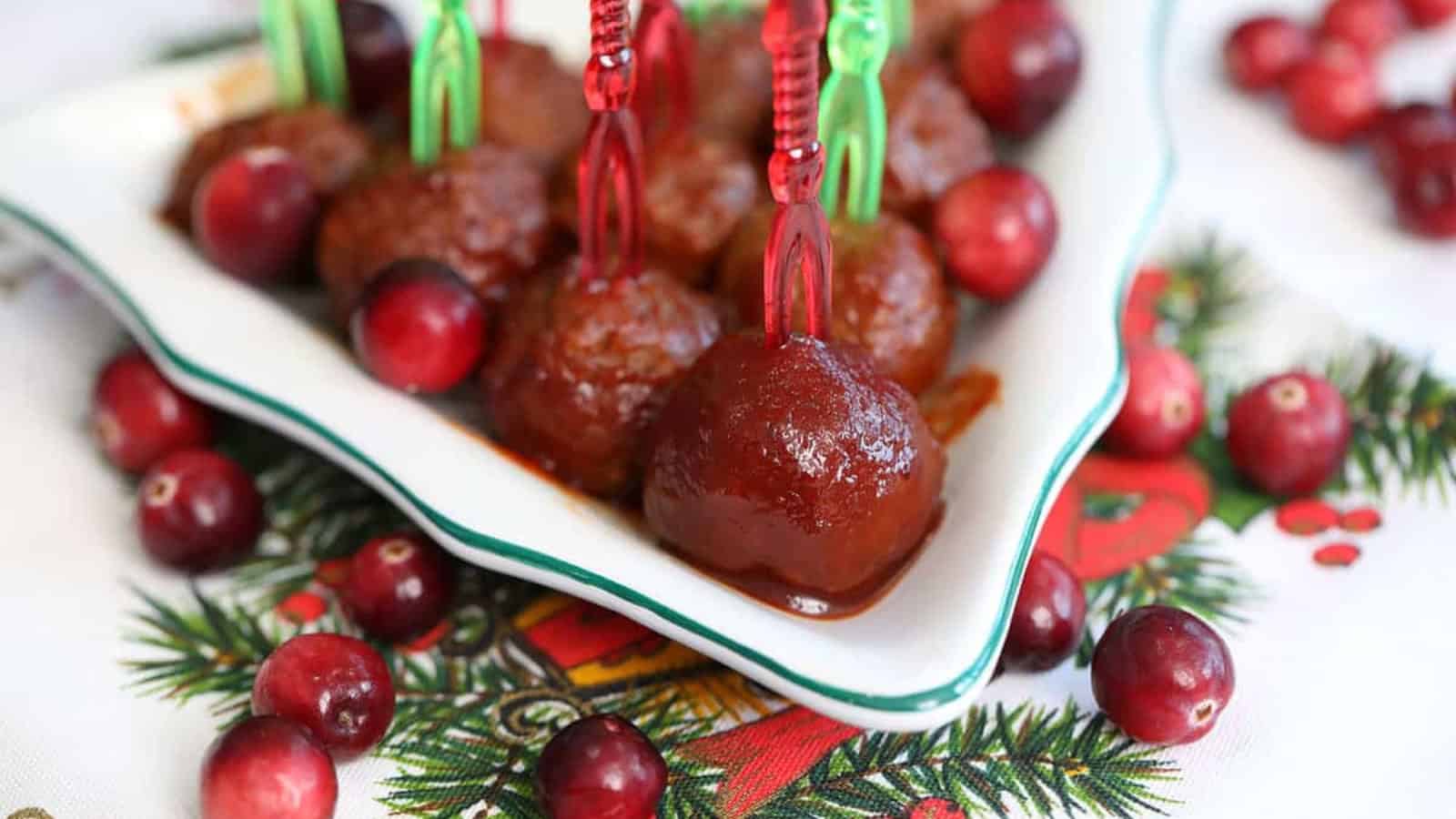 Cocktail meatballs coated in cranberry sauce and topped with chopped parsley.