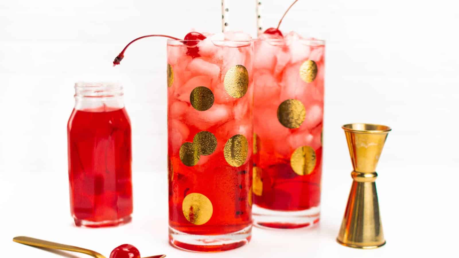 Dirty Shirley cocktail with lemon-lime soda, grenadine, and maraschino cherries.
