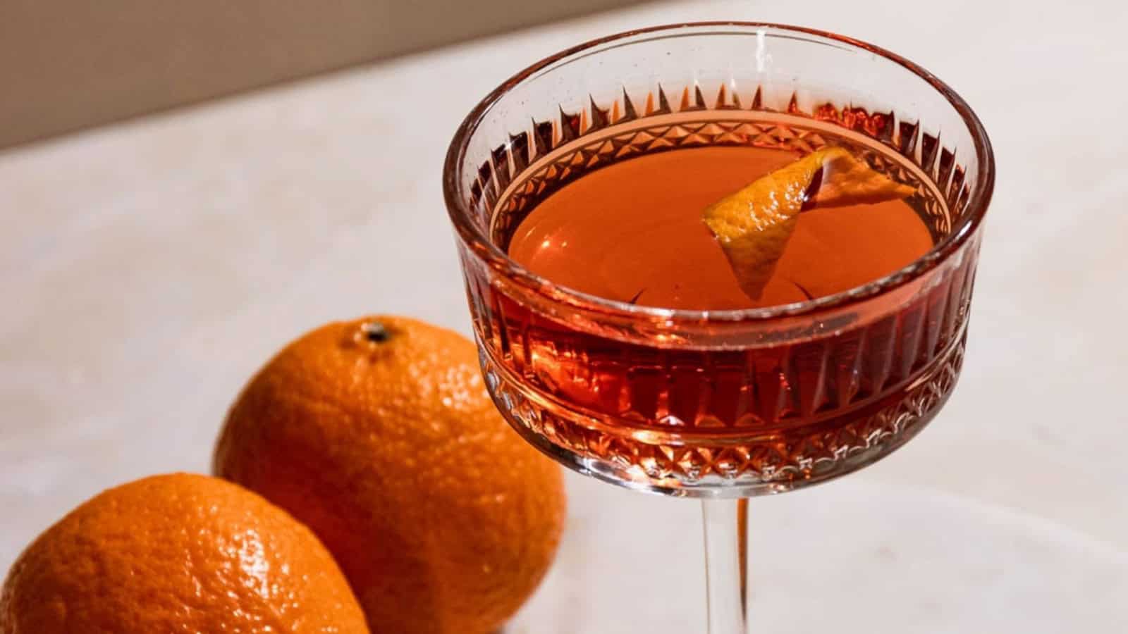 El Presidente cocktail served in a coupe glass with a citrus twist.