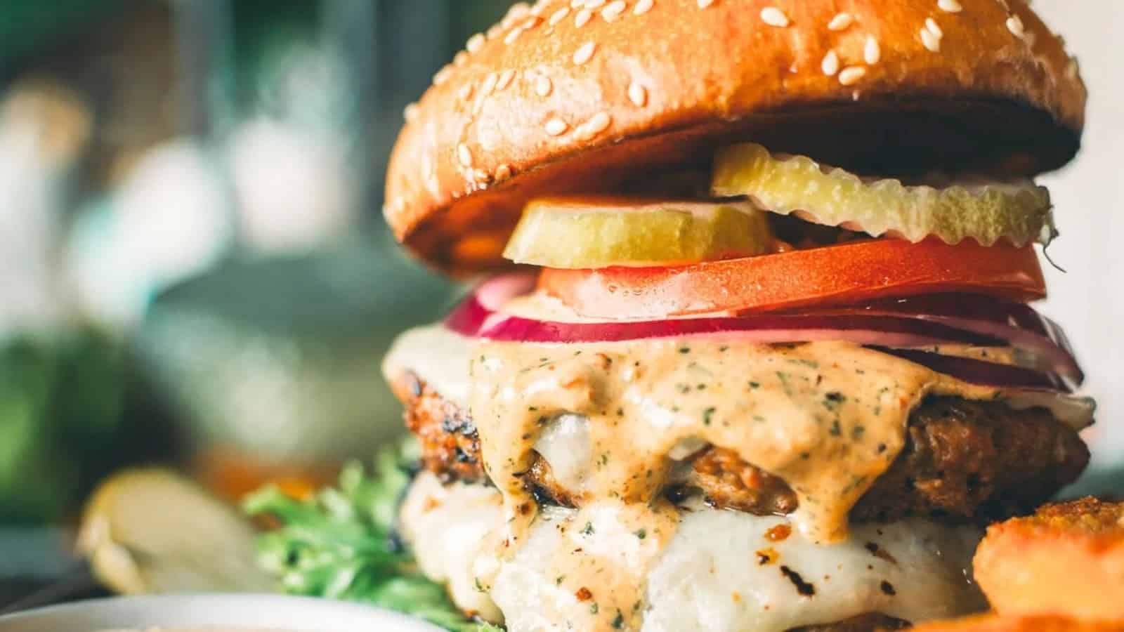 Ground turkey burger topped with fresh lettuce, tomato, and onion.