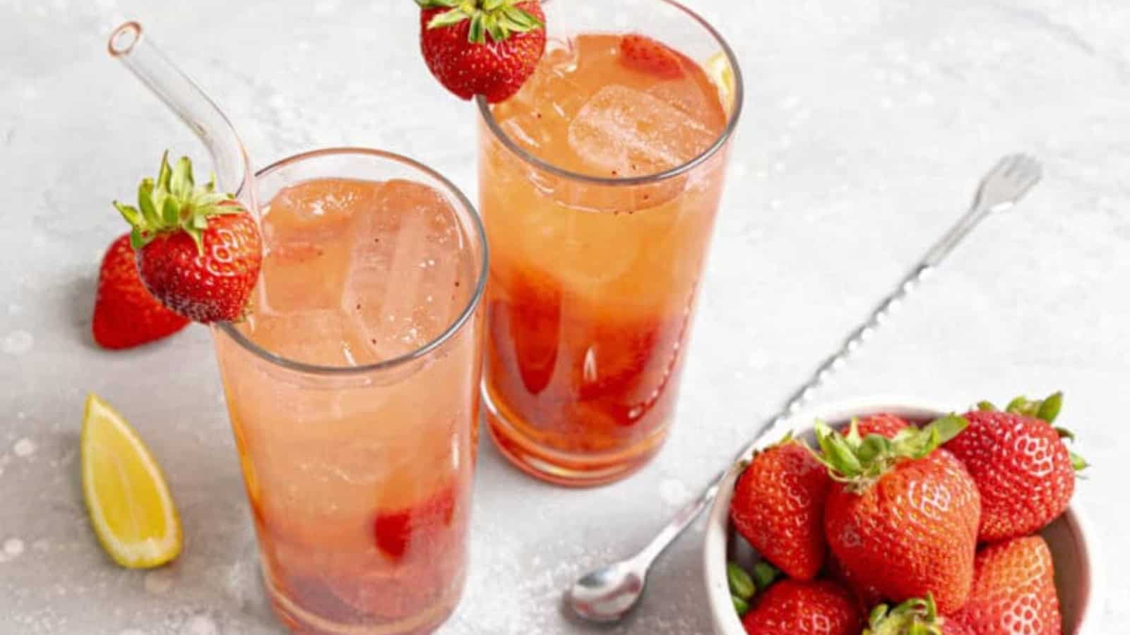 Freckled lemonade with strawberries and lemon served over ice.
